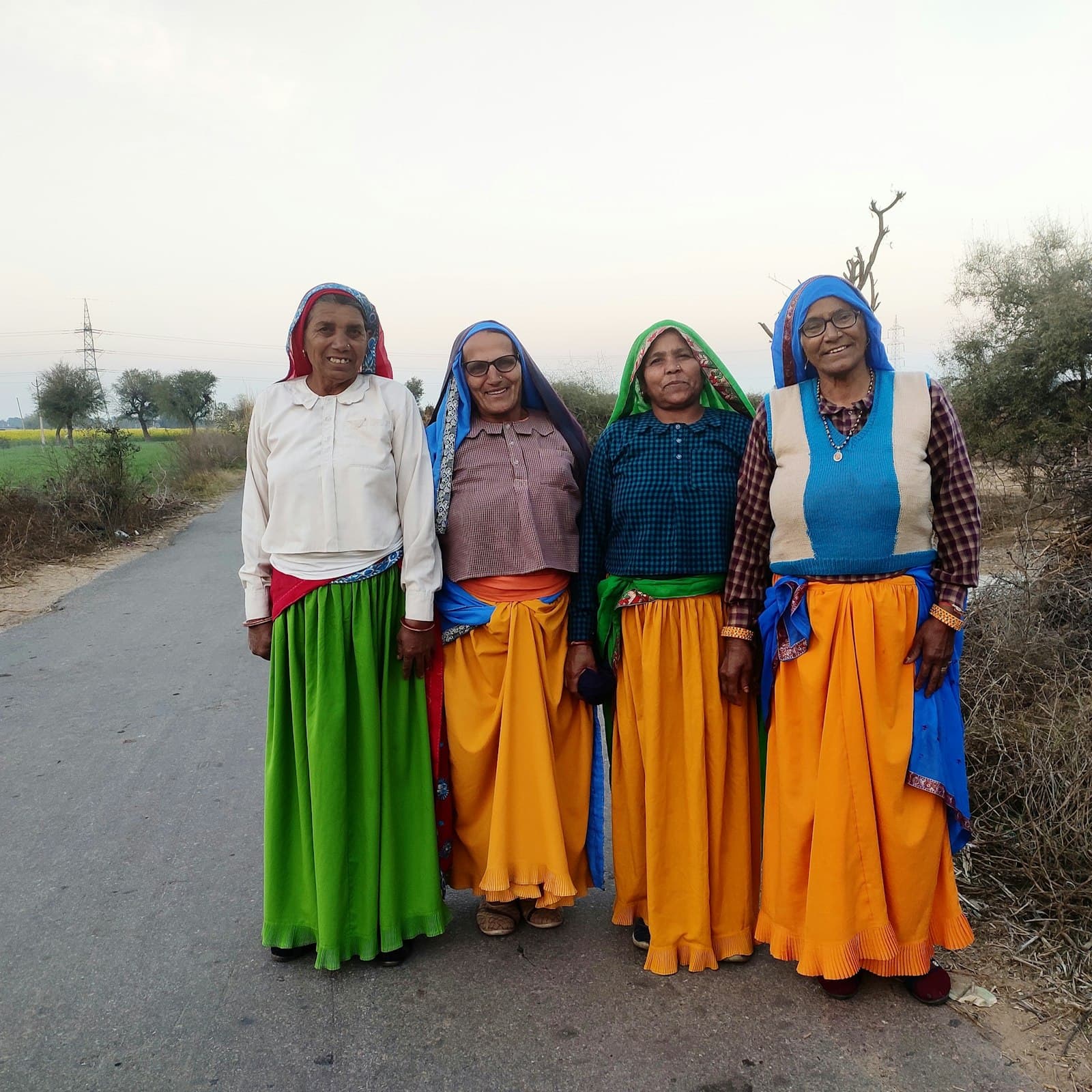 Four women in traditional dress standing together