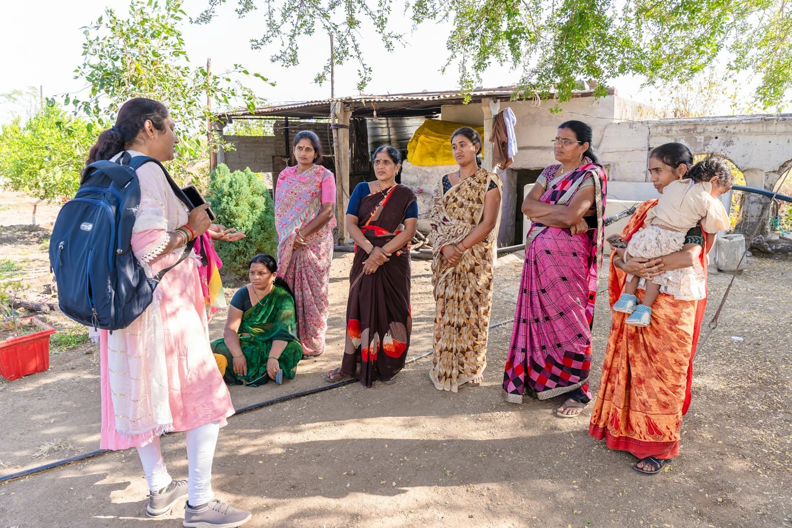 A health worker talking with women in a village