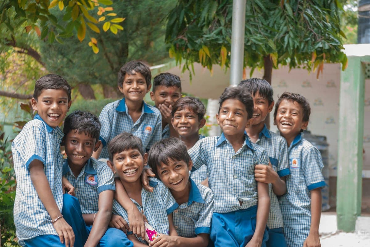 Schoolboys in uniform smiling together