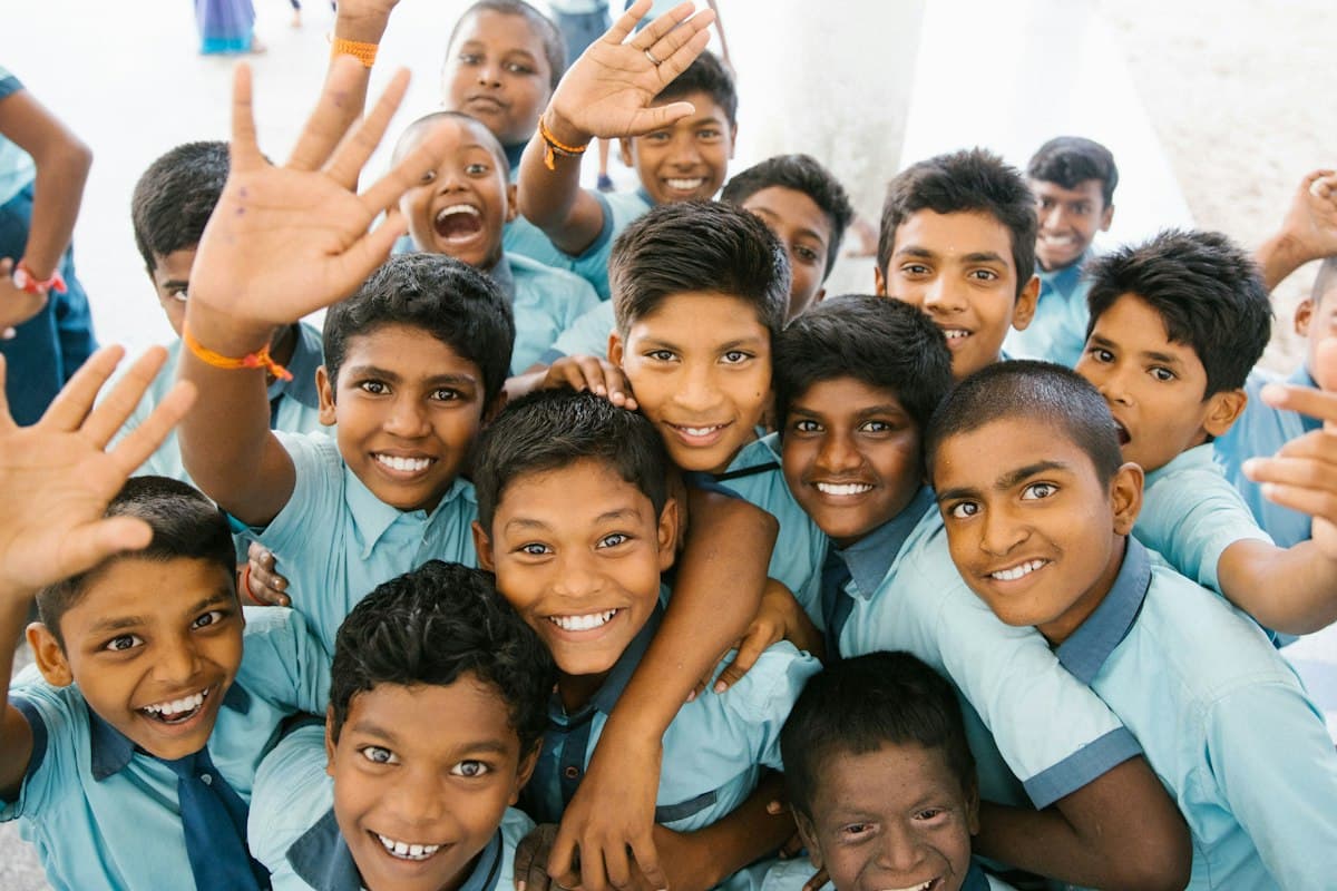 Children in school uniform waving happily